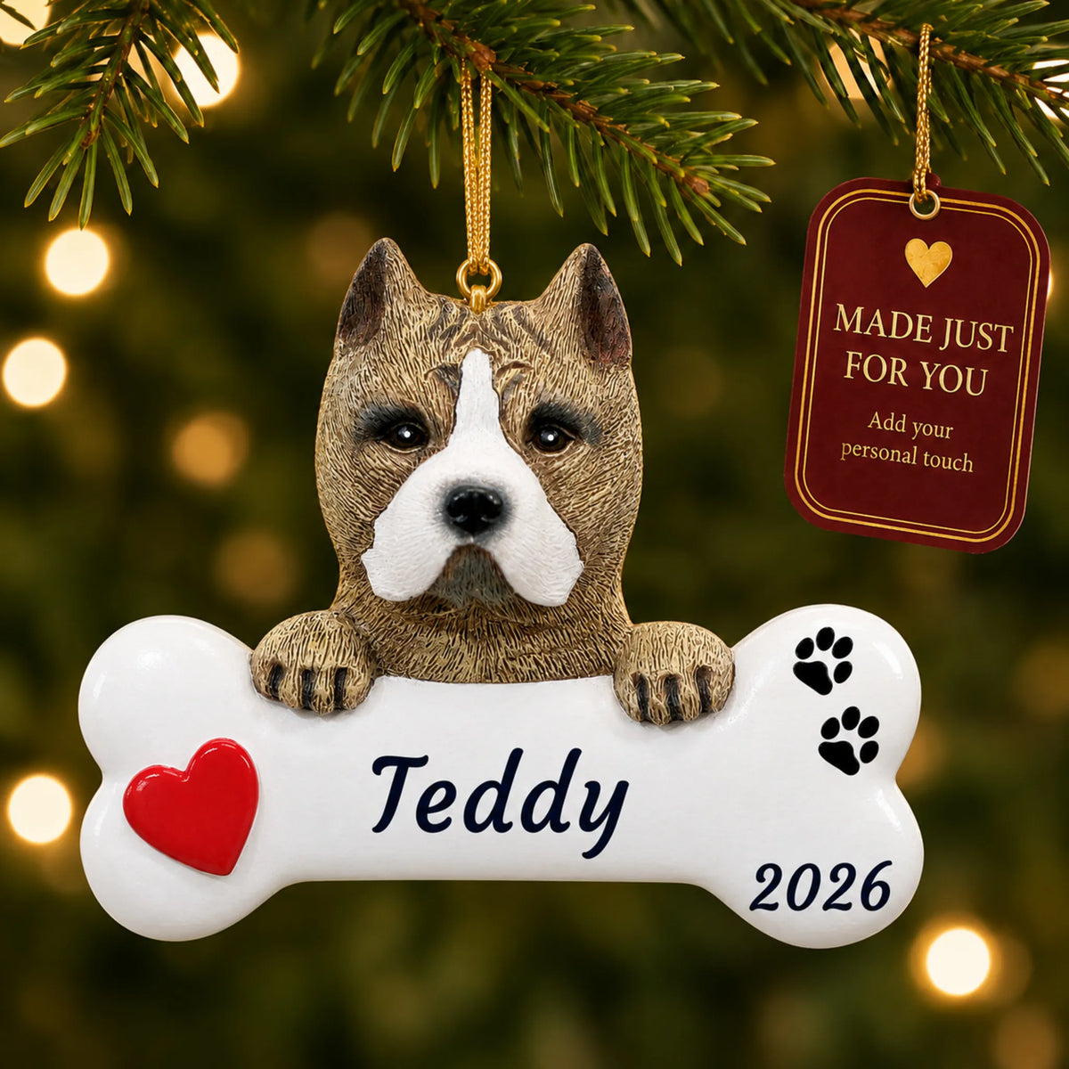Pit Bull Dog Bone christmas ornament hanging on a lit Christmas tree with a Made Just For You gift tag