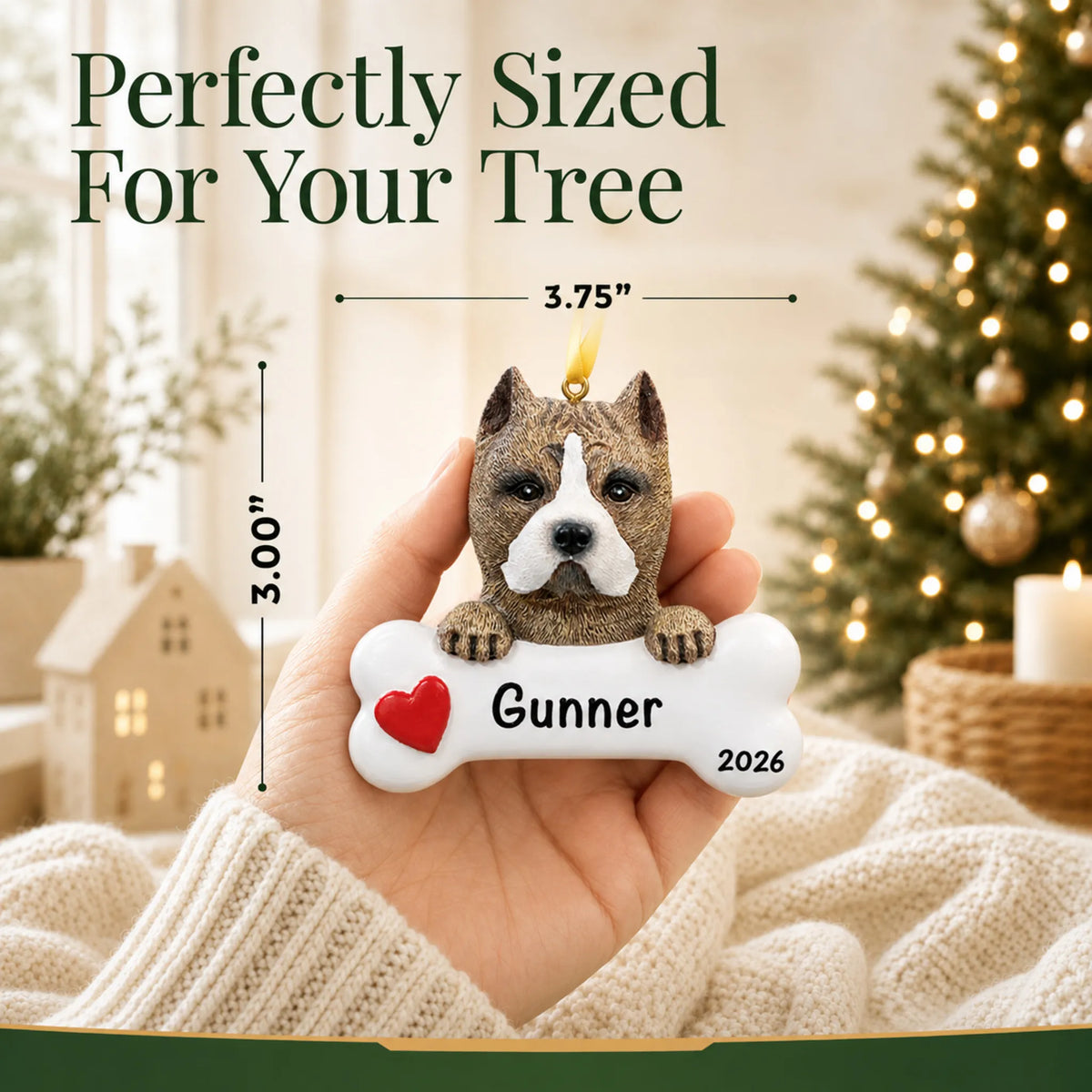 Hand holding the personalized pit bull Christmas ornament to show its 3.75 inch width