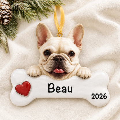Personalized French bulldog dog bone Christmas ornament resting on a soft white blanket with pine and pinecones