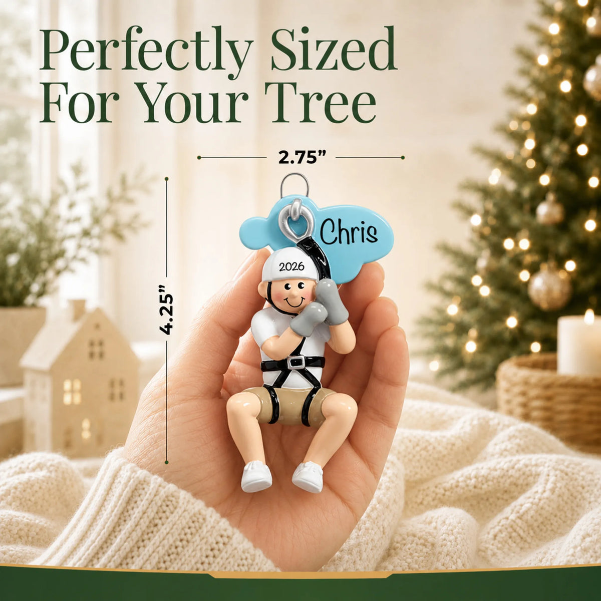 Size guide: the personalized zip line boy christmas ornament is 2.75 in wide by 4.25 in tall, shown in hand