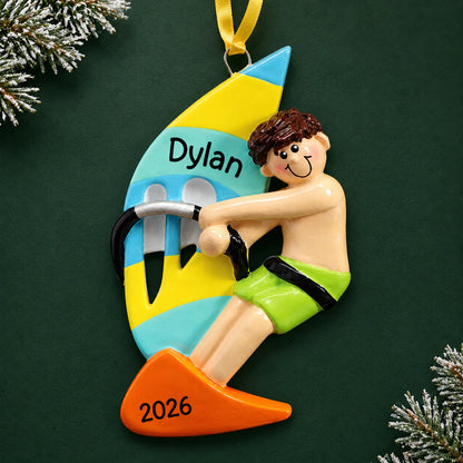 Personalized windsurfing guy christmas ornament on a dark green pine background