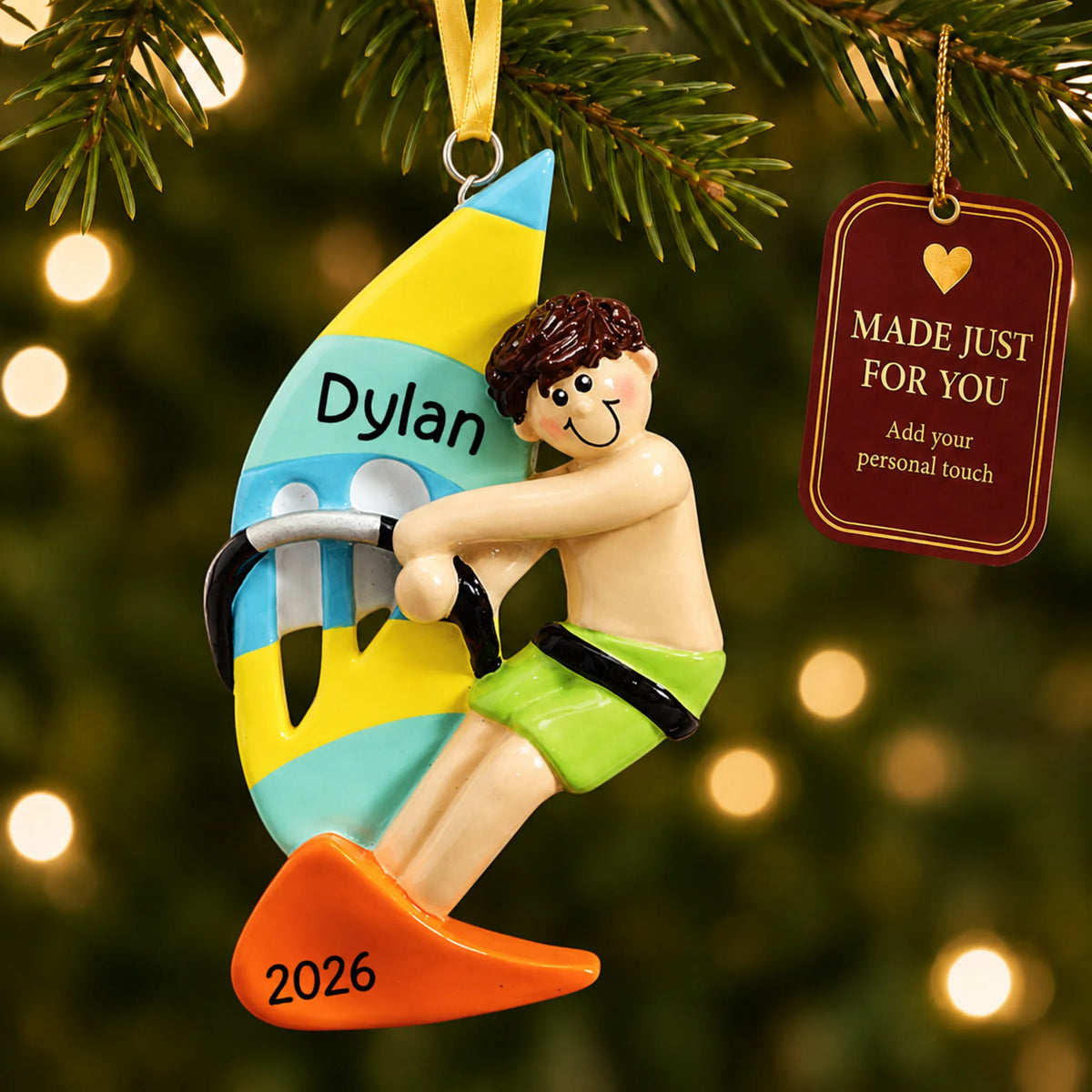 Windsurfing guy christmas ornament hanging on a lit Christmas tree with a Made Just For You gift tag
