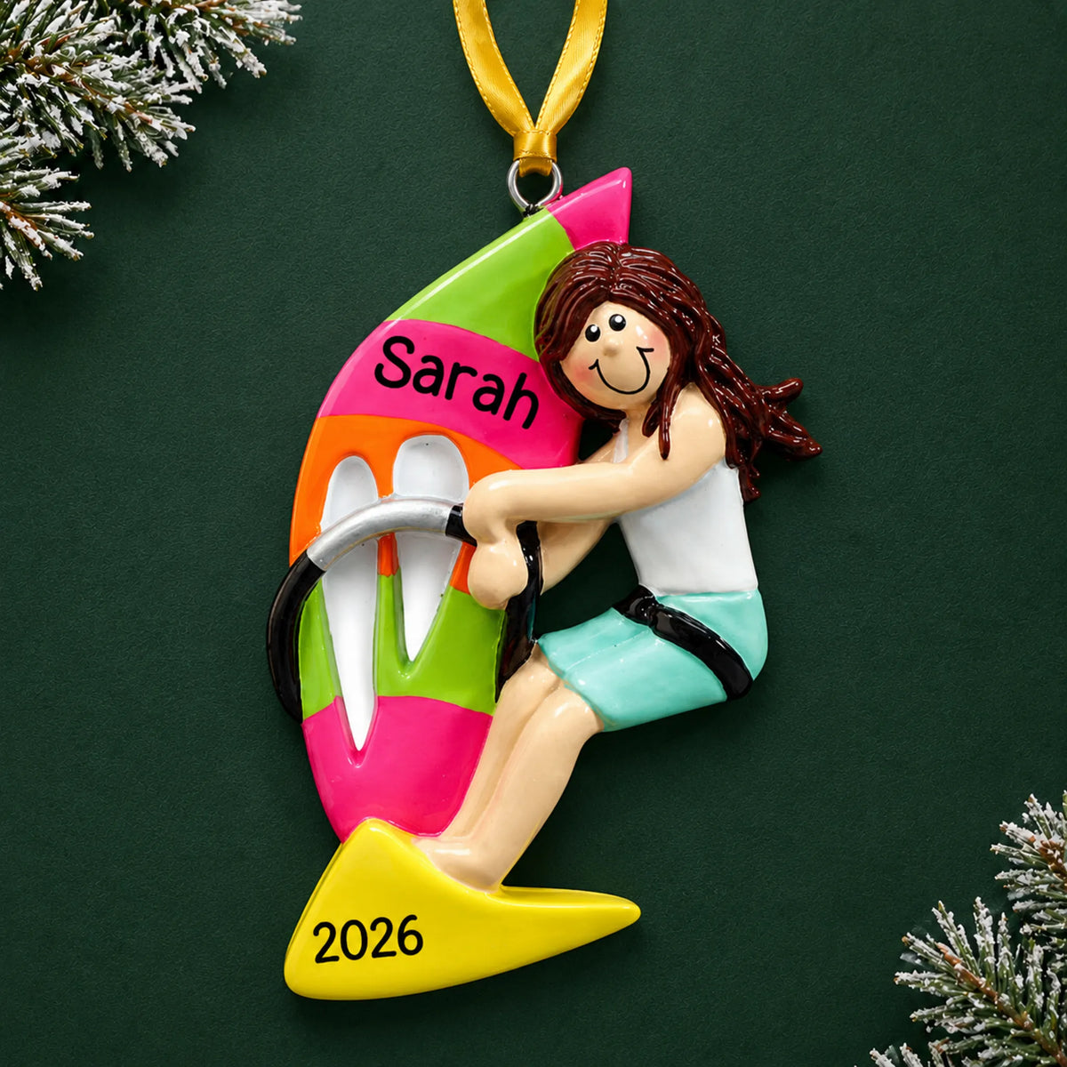 Personalized windsurfing girl christmas ornament on a dark green pine background