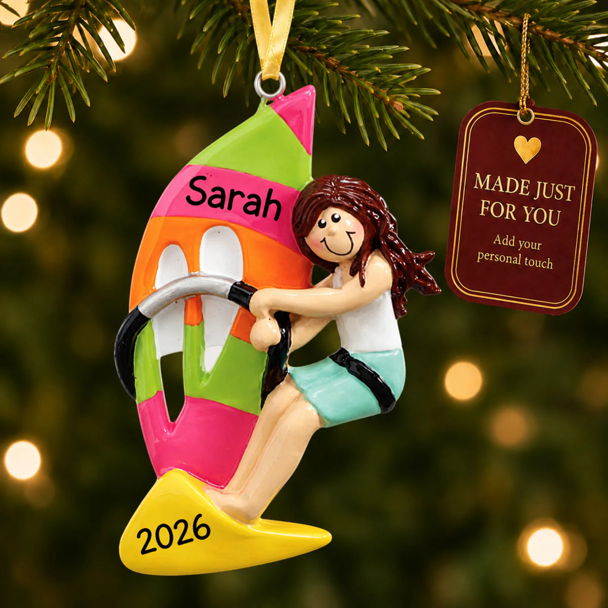 Windsurfing girl christmas ornament hanging on a lit Christmas tree with a Made Just For You gift tag