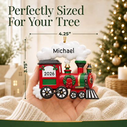 Size guide: the personalized holiday train christmas ornament shown in hand next to a Christmas tree