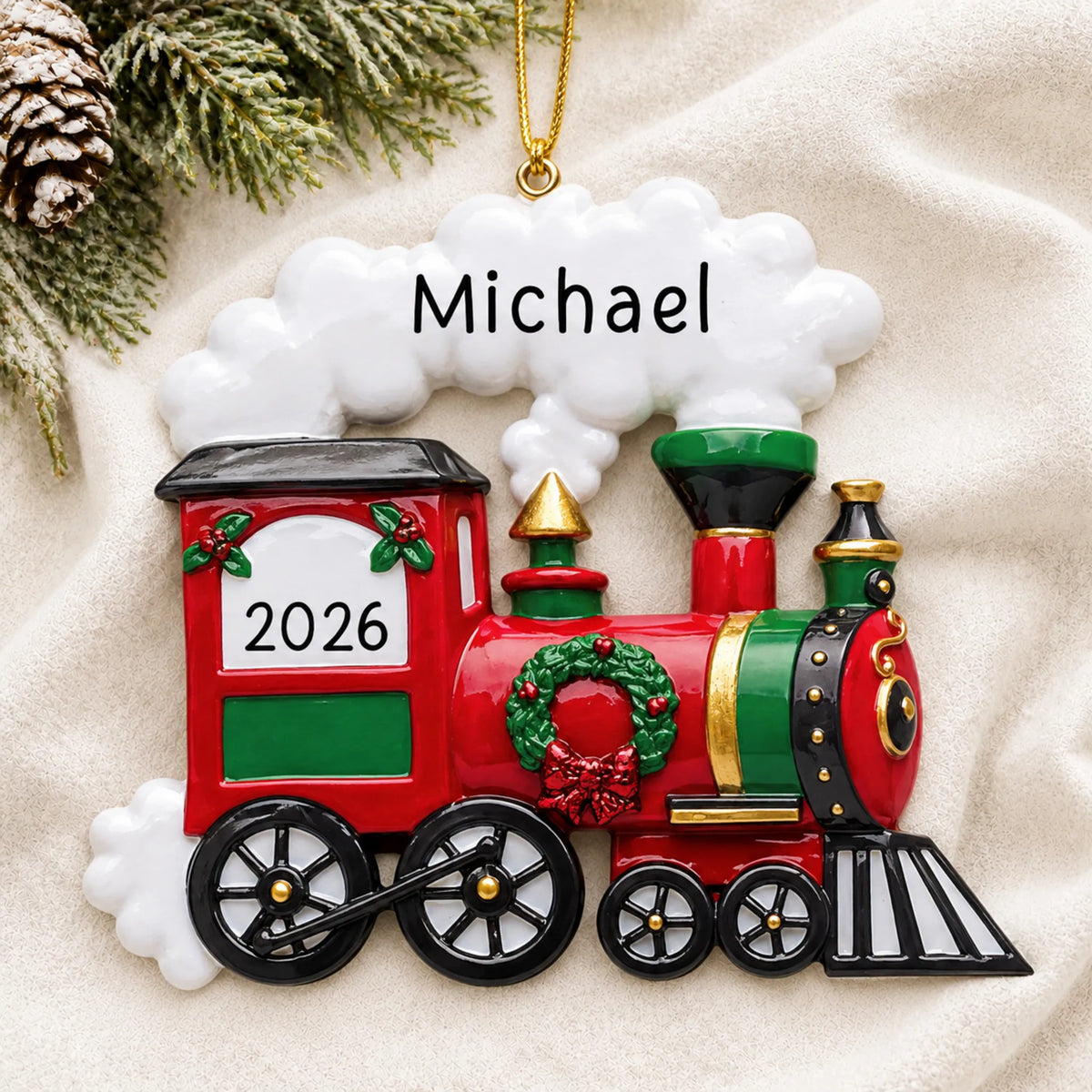 Personalized holiday train christmas ornament laid on a soft white knit blanket