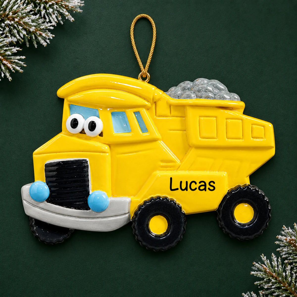 Personalized dump truck christmas ornament on a dark green pine background