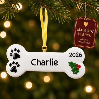 White Dog Bone christmas ornament hanging on a lit Christmas tree with a Made Just For You gift tag