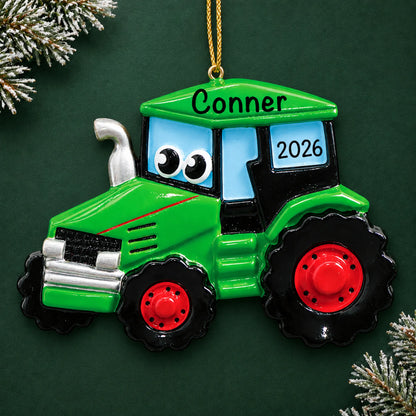 Personalized green tractor christmas ornament on a dark green pine background