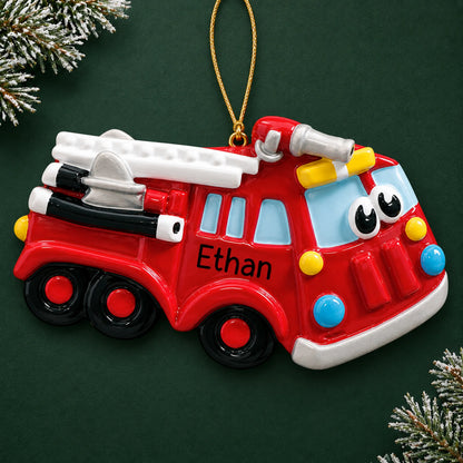 Personalized fire truck christmas ornament on a dark green pine background