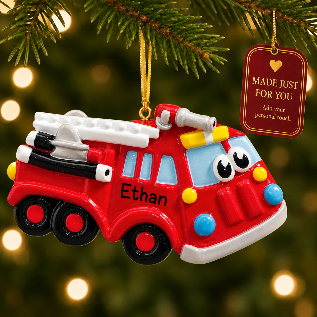 Fire truck christmas ornament hanging on a lit Christmas tree with a Made Just For You gift tag
