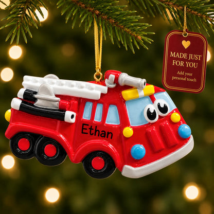 Fire truck christmas ornament hanging on a lit Christmas tree with a Made Just For You gift tag