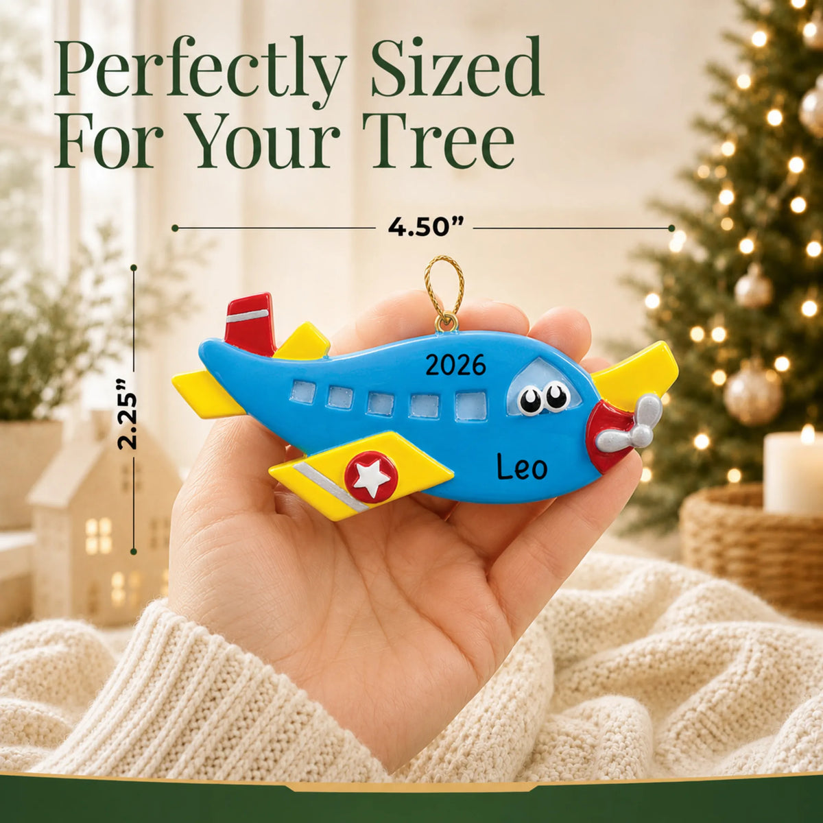 Size guide: the personalized blue airplane christmas ornament is 4.50 in wide by 2.25 in tall, shown in hand