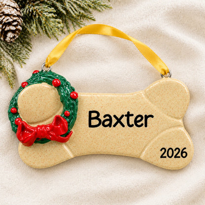 Personalized Brown Dog Bone christmas ornament laid on a soft white knit blanket