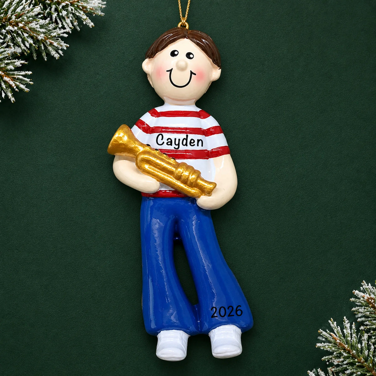 Personalized trumpet boy christmas ornament on a dark green pine background
