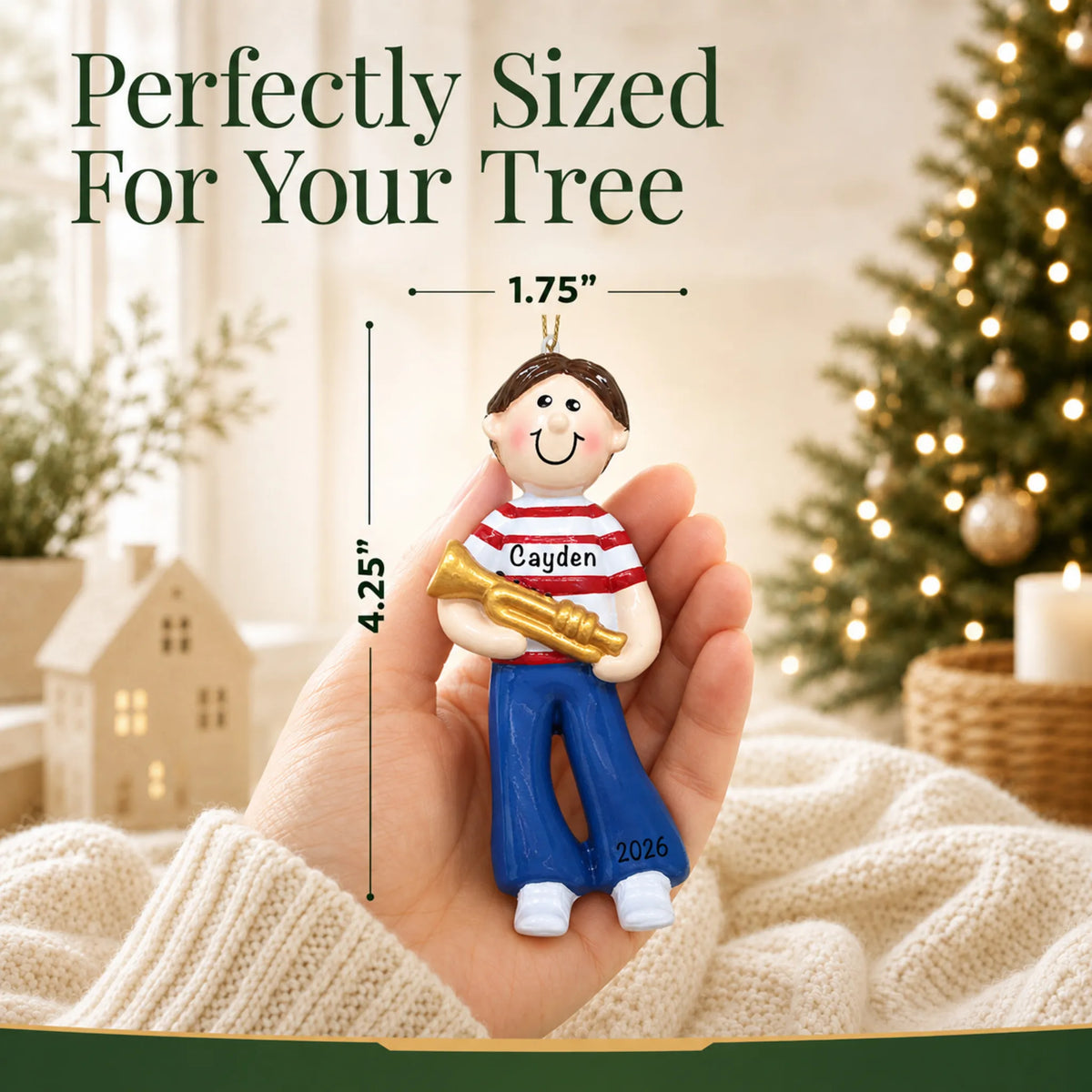 Size guide: the personalized trumpet boy christmas ornament is 1.75 in wide by 4.25 in tall, shown in hand