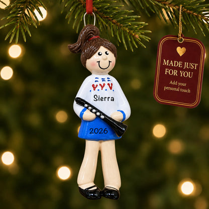 Clarinet girl christmas ornament hanging on a lit Christmas tree with a Made Just For You gift tag