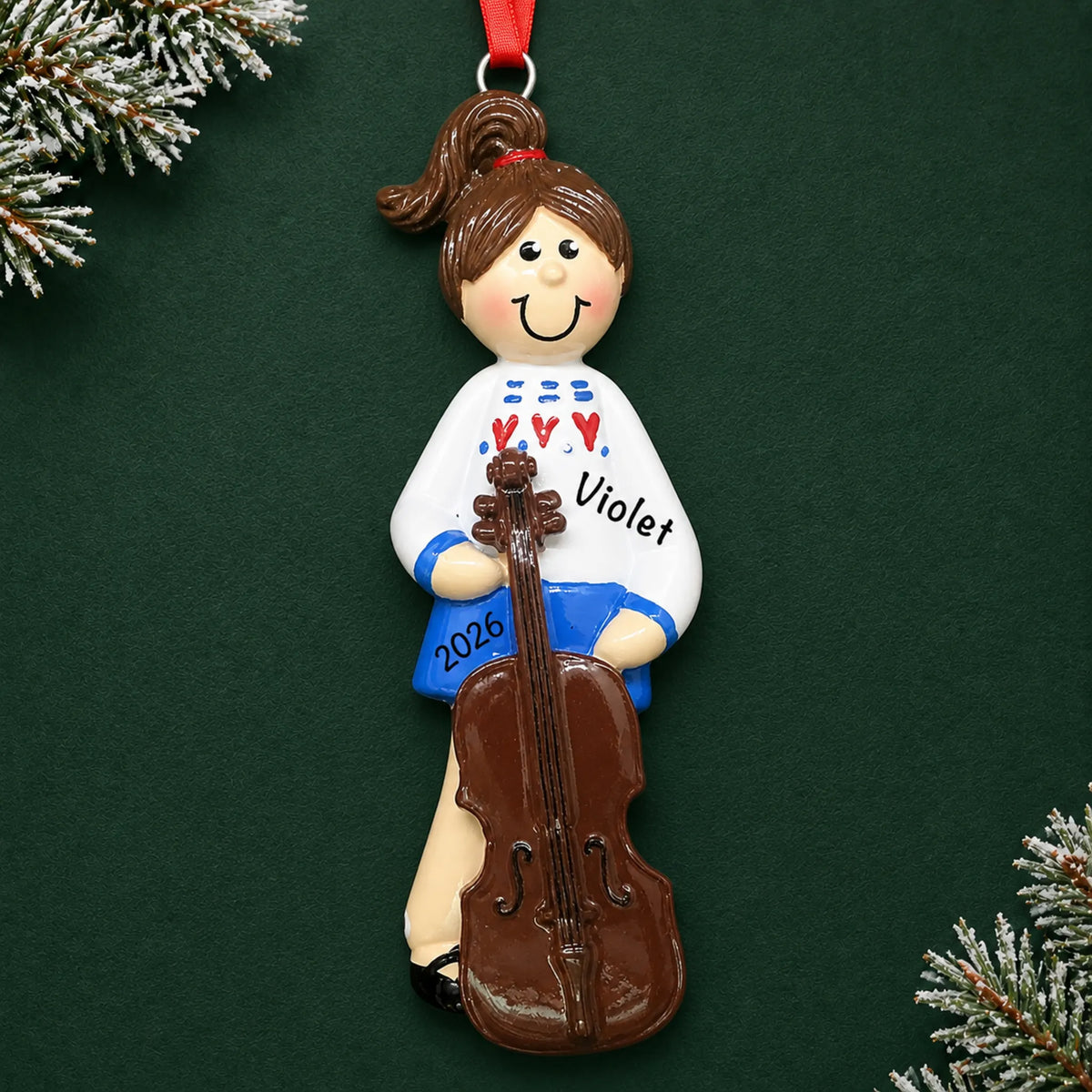 Personalized cello girl christmas ornament on a dark green pine background