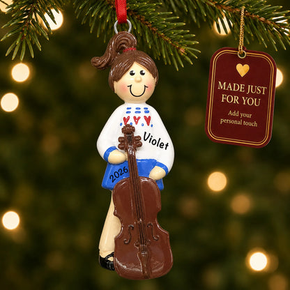 Cello girl christmas ornament hanging on a lit Christmas tree with a Made Just For You gift tag