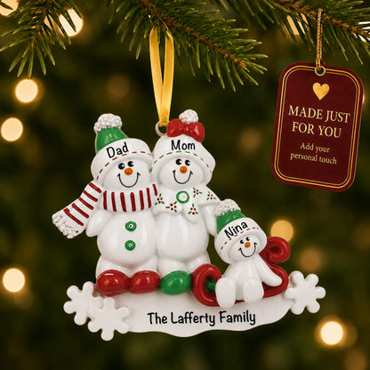 Snowman sled family of 3 christmas ornament hanging on a lit Christmas tree with a Made Just For You gift tag