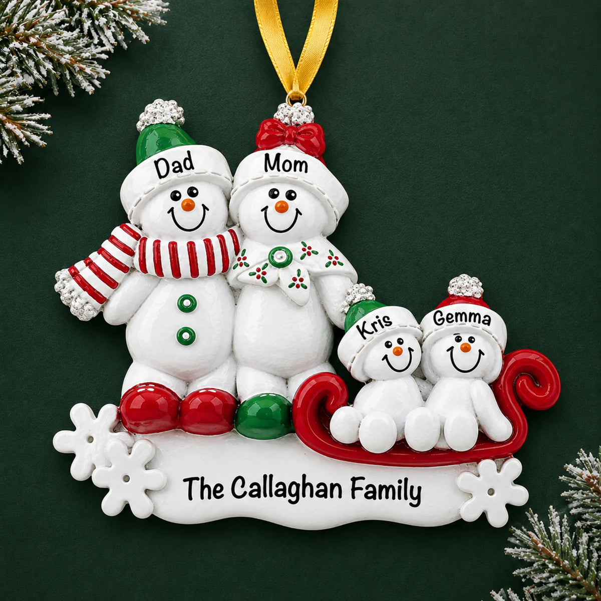 Personalized snowman sled family of 4 christmas ornament on a dark green pine background