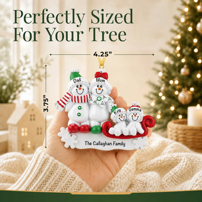 Size guide: the personalized snowman sled family of 4 christmas ornament is 4.25 in wide by 3.75 in tall, shown in hand