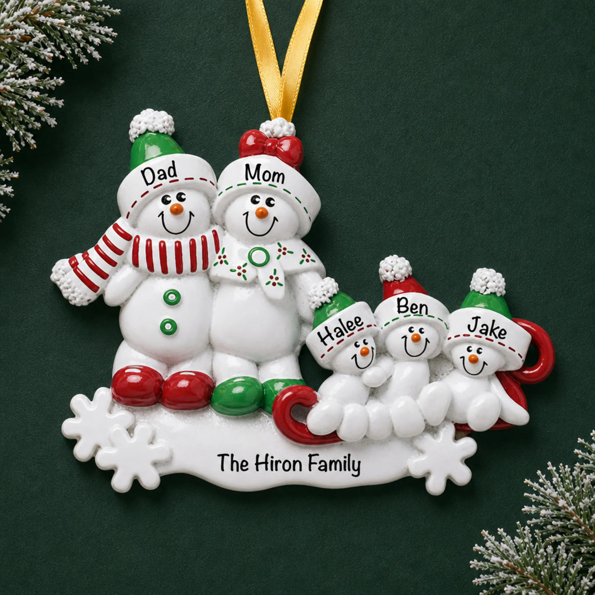Personalized snowman sled family of 5 christmas ornament on a dark green pine background