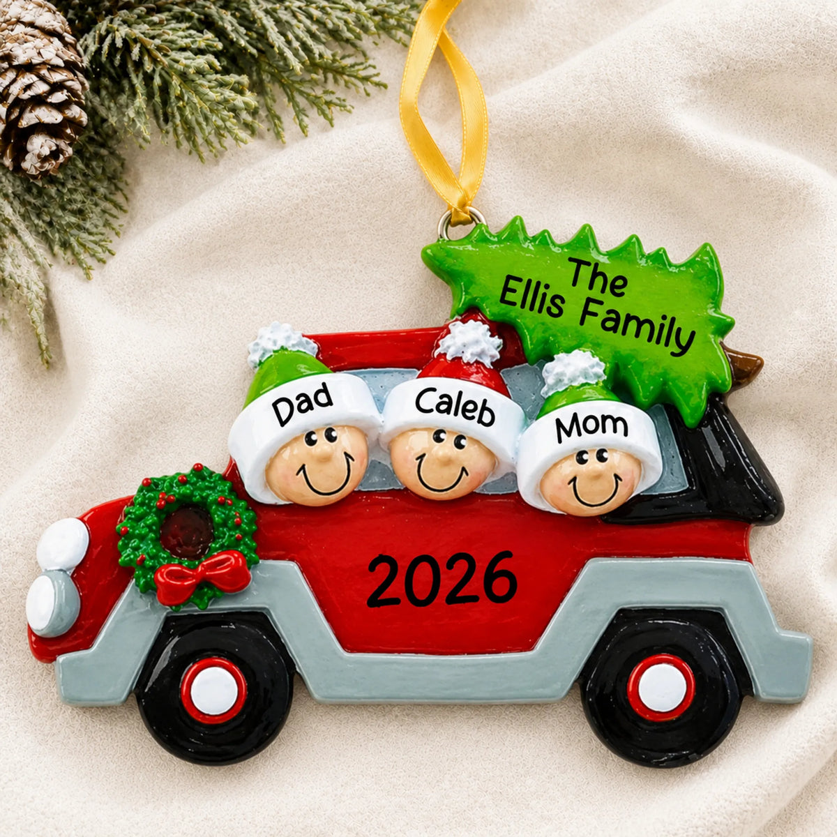 Personalized christmas tree car family of 3 ornament laid on a soft white knit blanket