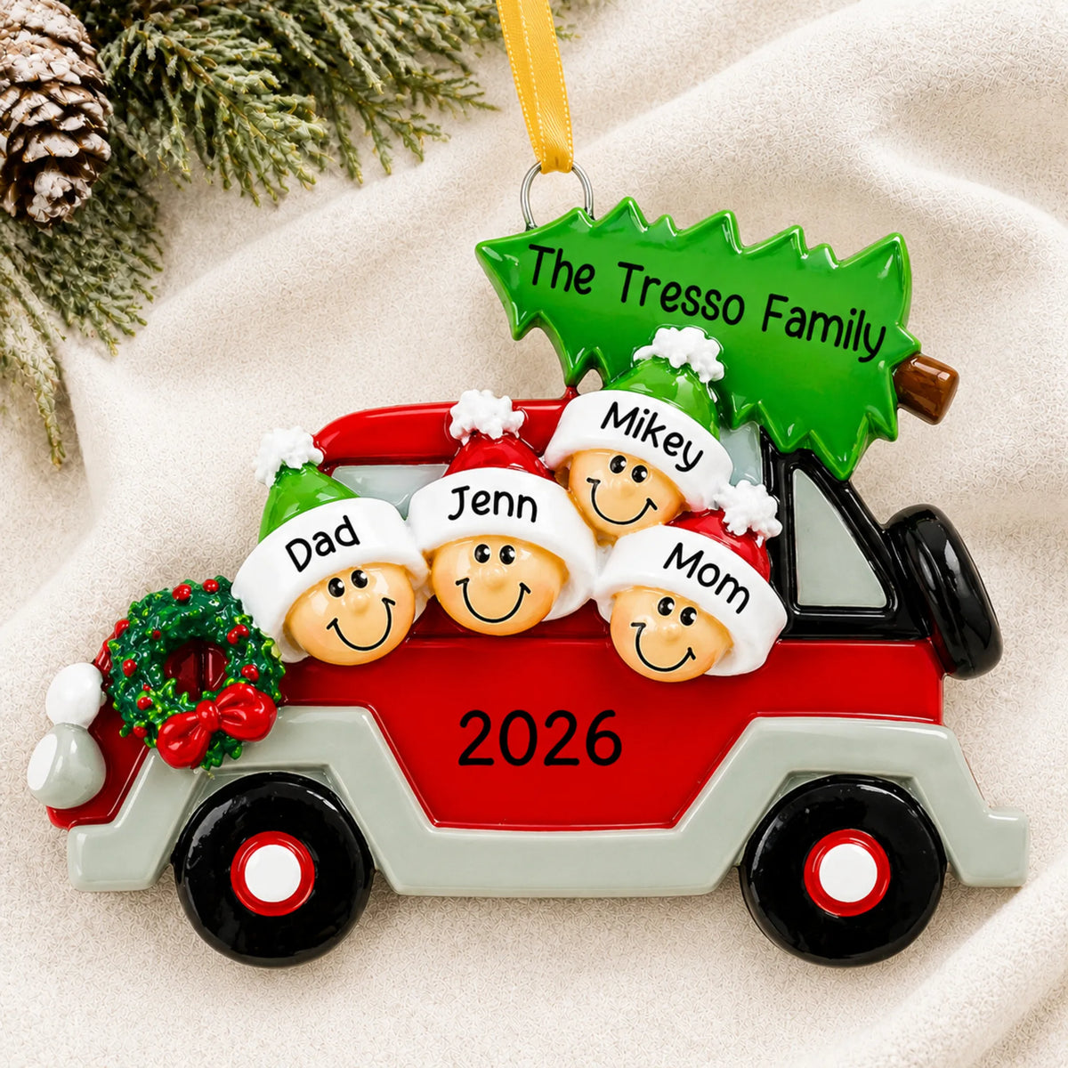 Personalized christmas tree car family of 4 ornament laid on a soft white knit blanket