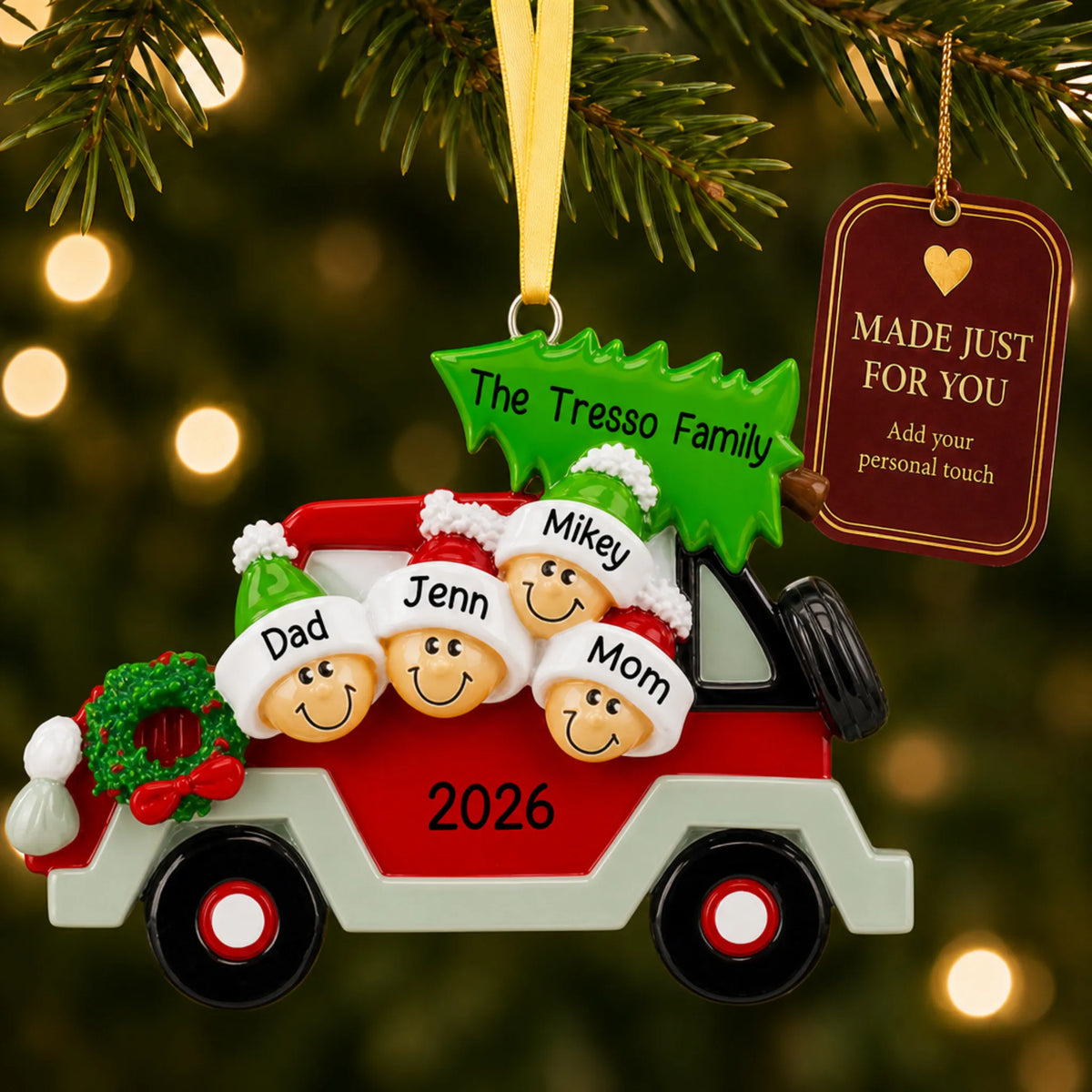 Christmas tree car family of 4 ornament hanging on a lit Christmas tree with a Made Just For You gift tag