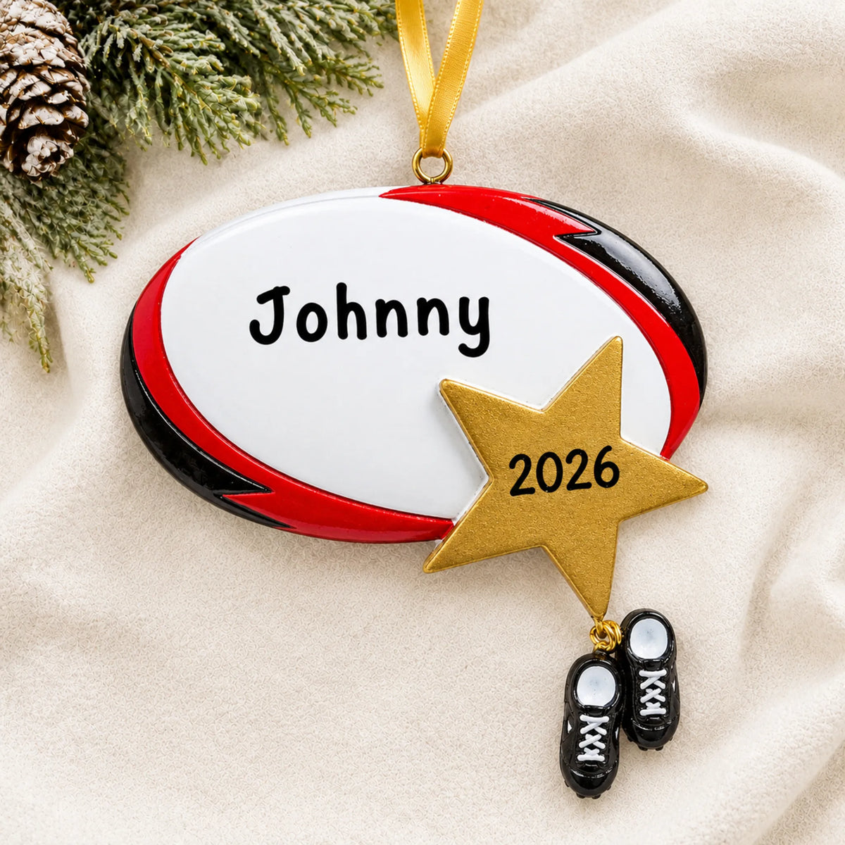 Personalized rugby star christmas ornament laid on a soft white knit blanket