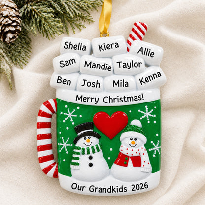 Personalized cocoa mug family Christmas ornament, marshmallow names above two snowmen on a green mug