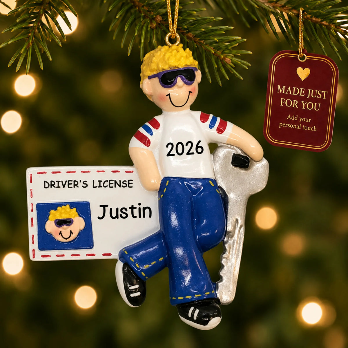 New driver's license blonde boy christmas ornament hanging on a lit Christmas tree with a Made Just For You gift tag