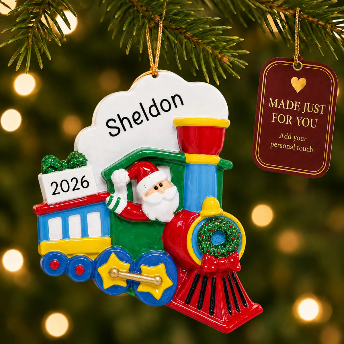 Santa Train christmas ornament hanging on a lit Christmas tree with a Made Just For You gift tag