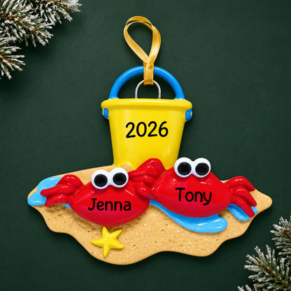 Personalized crab couple beach christmas ornament on a dark green pine background