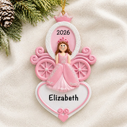 Personalized princess carriage christmas ornament laid on a soft white knit blanket