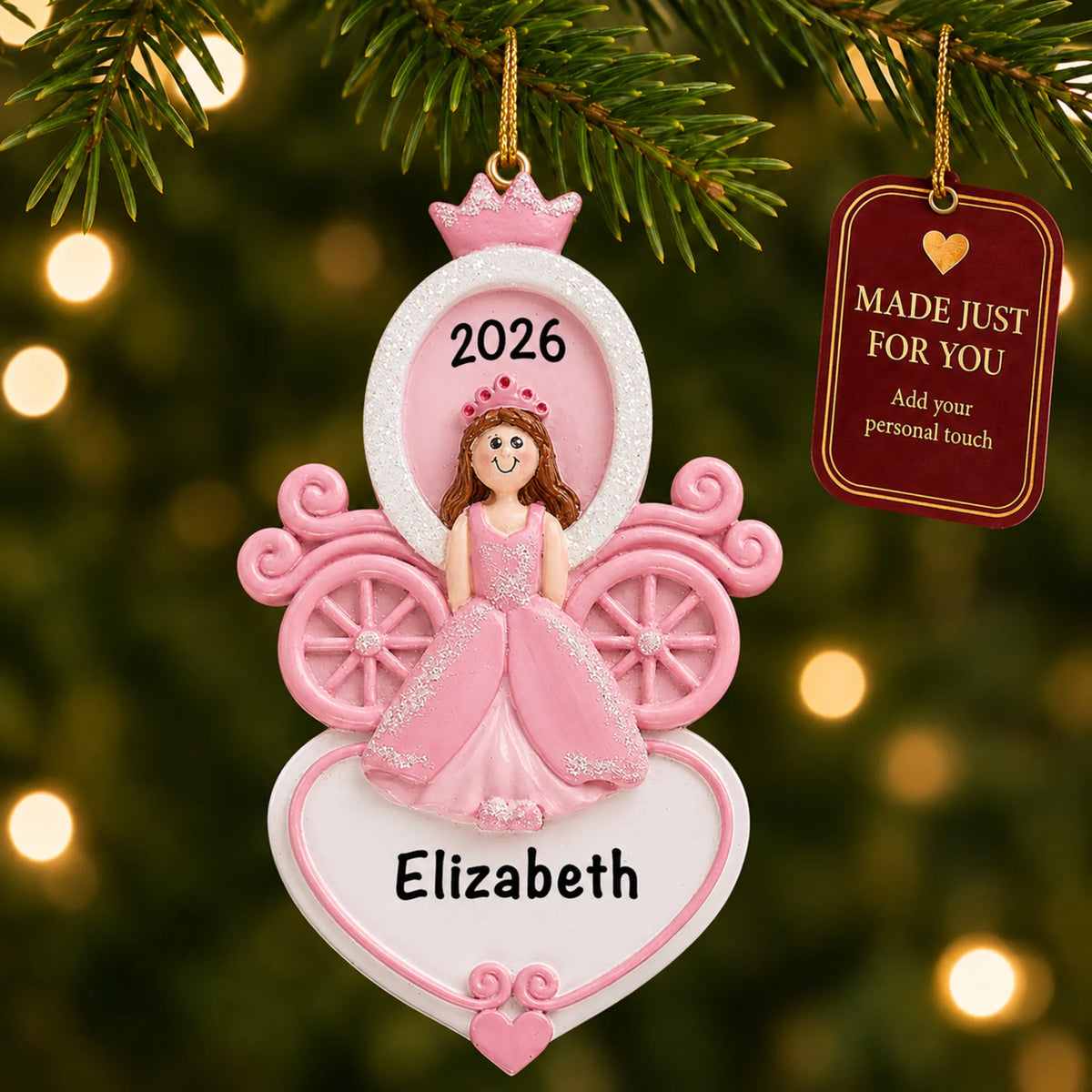 Princess carriage christmas ornament hanging on a lit Christmas tree with a Made Just For You gift tag