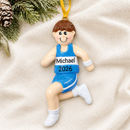 Personalized track runner boy christmas ornament laid on a soft white knit blanket