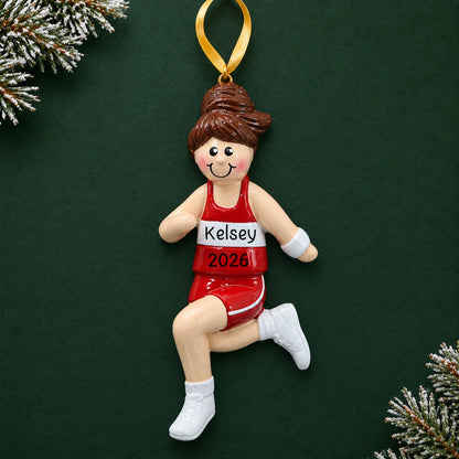 Personalized track girl runner christmas ornament on a dark green pine background