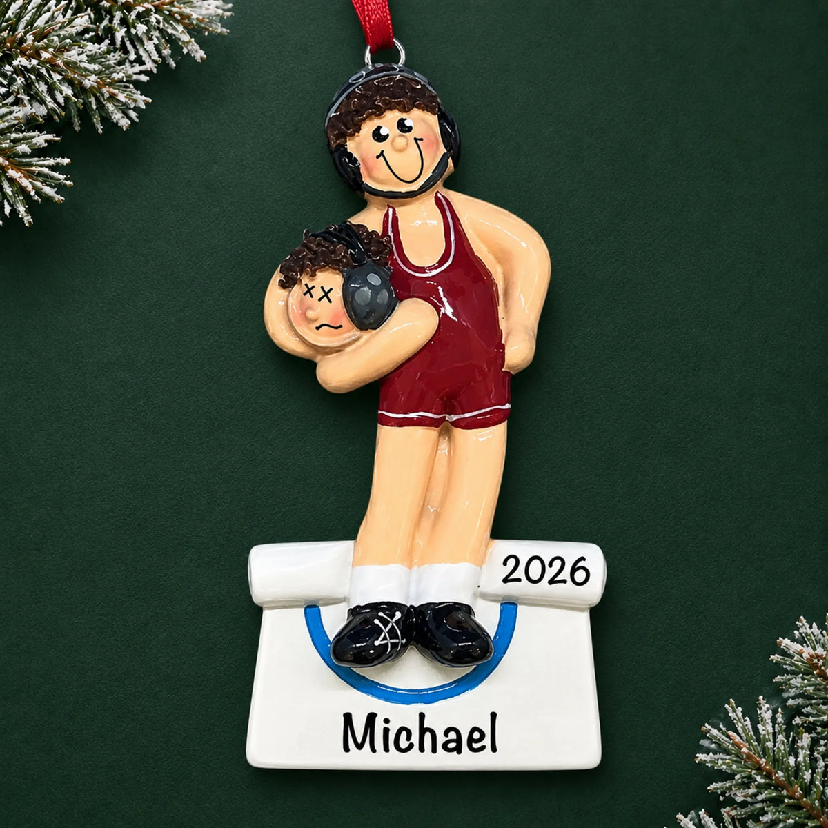 Personalized male wrestler in a red singlet christmas ornament on a dark green pine background