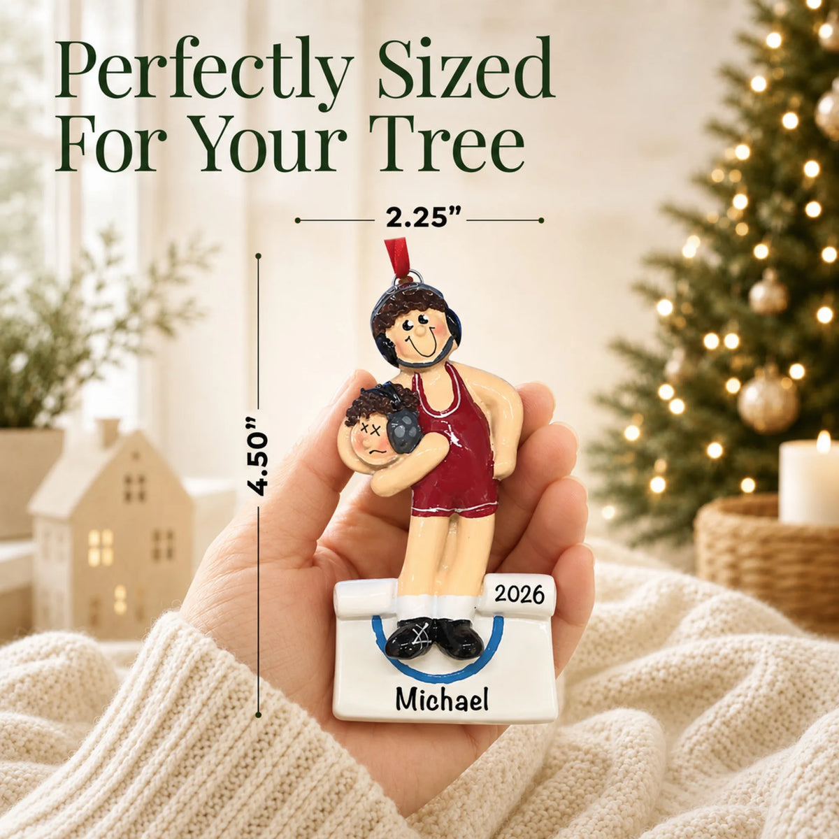 Size guide: the personalized male wrestler in a red singlet christmas ornament is 2.25 in wide by 4.50 in tall, shown in hand