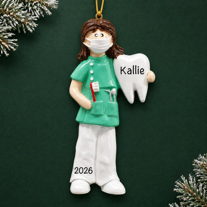 Personalized female dental professional christmas ornament on a dark green pine background