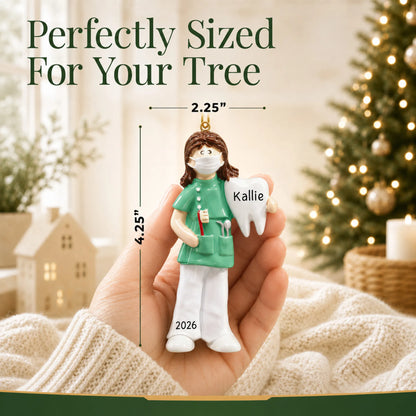 Size guide: the personalized female dental professional christmas ornament is 2.25 in wide by 4.25 in tall, shown in hand