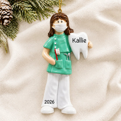 Personalized female dental professional christmas ornament laid on a soft white knit blanket