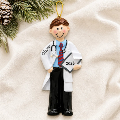 Personalized male doctor christmas ornament laid on a soft white knit blanket