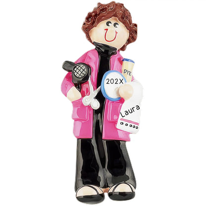 A personalized ornament depicting a female hairdresser in a pink jacket and black pants, holding a microphone and a sign with 'Laura' written on it, indicating a customization option for names.