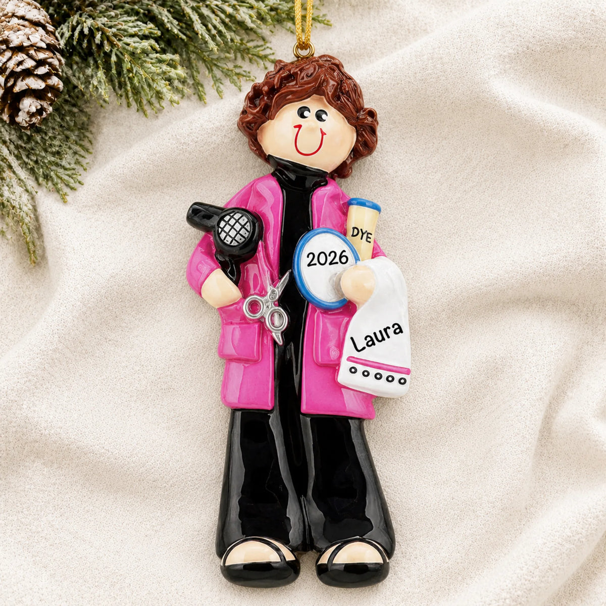Personalized hairdresser stylist christmas ornament laid on a soft white knit blanket