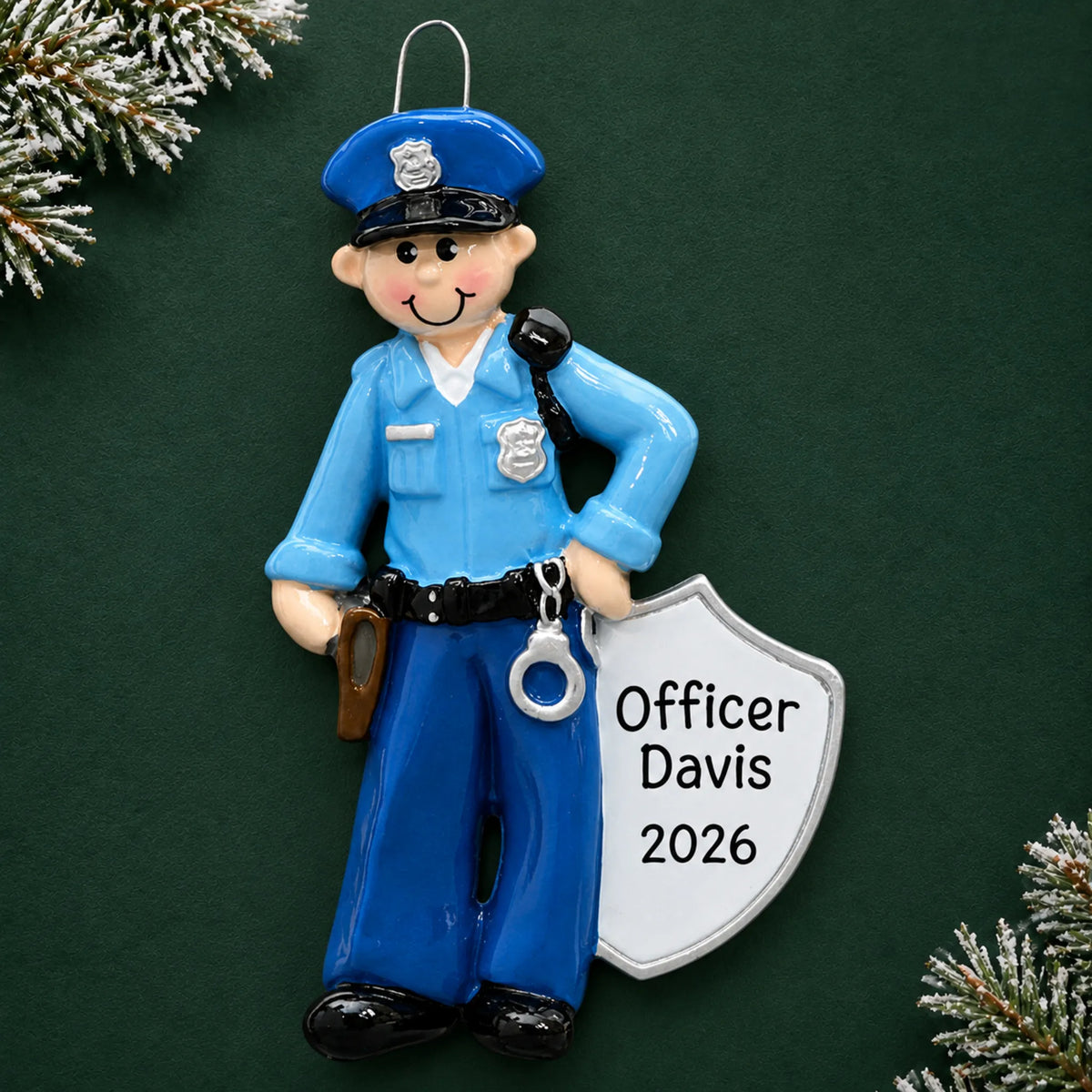 Personalized police officer christmas ornament on a dark green pine background