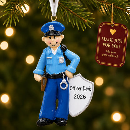 Police officer christmas ornament hanging on a lit Christmas tree with a Made Just For You gift tag