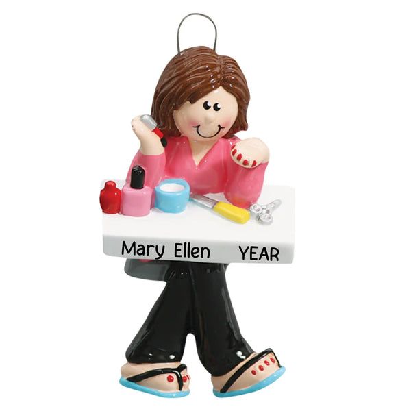Personalized Christmas ornament featuring a female nail technician in a pink shirt seated at a white table with nail polish and tools, ready for custom name engraving.